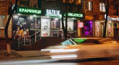cars parked in front of store during night time